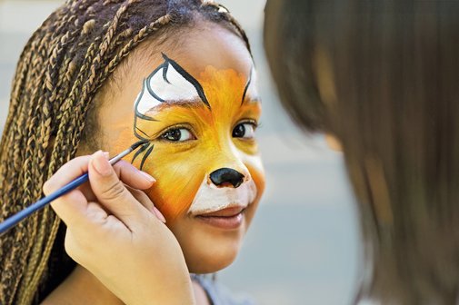Hamburger Tag der Familien Ein Mädchen lässt sich ein Löwengesicht schminken.